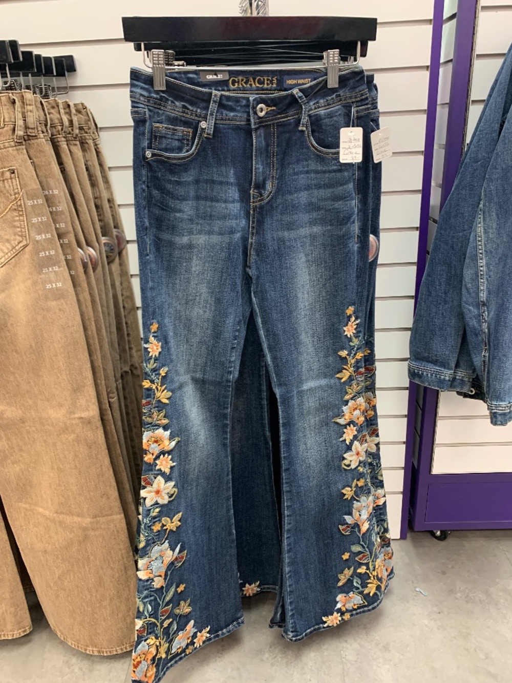 Grace in LA high rise flare with embroidered flowers down leg